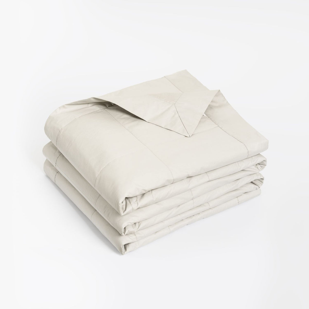 A coverlet corner folded back, displayed on a clean white background.