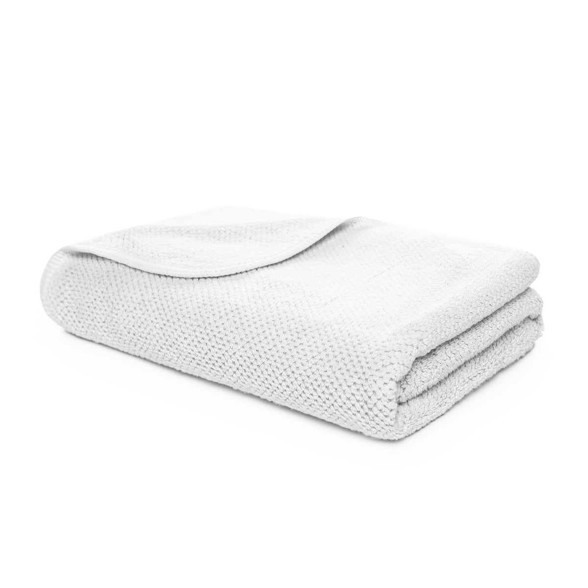 Folded white blanket on a white background