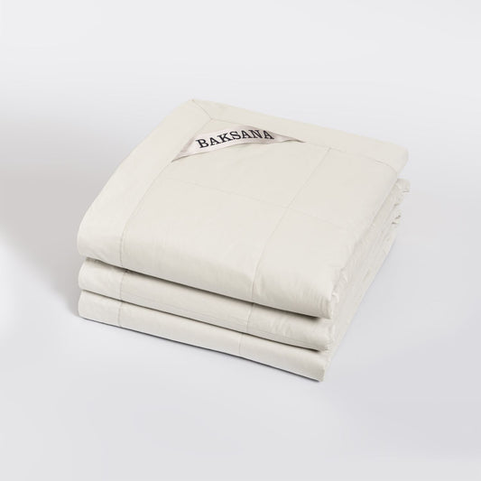 A coverlet called Luxury Espresso in Alabaster colour with 'BAKSANA' branding on a white background